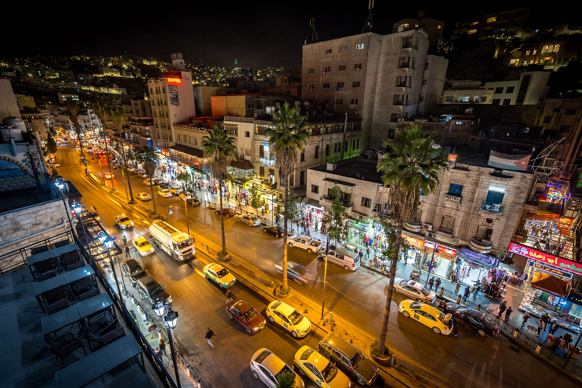 Night view of downtown Amman, Jordan, with busy streets, shops, and vibrant nightlife.