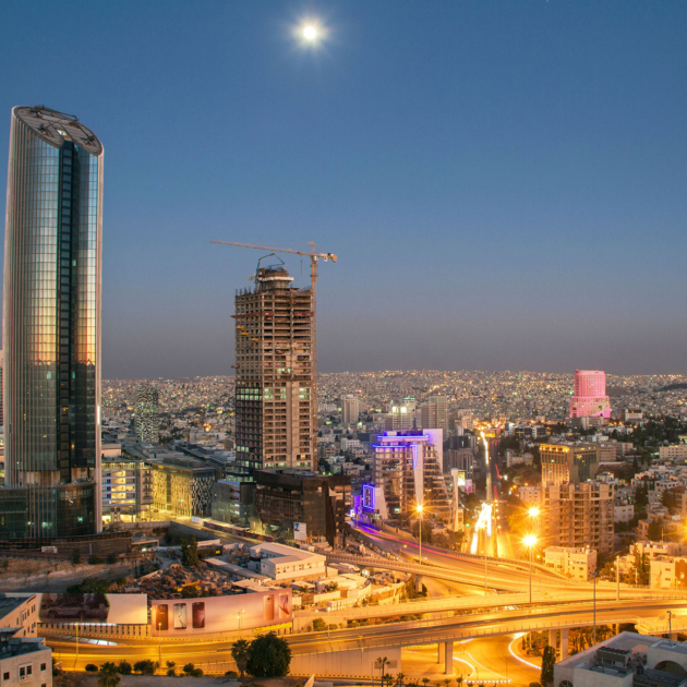 Amman city skyline at night with Abdali towers and Royal Hotel in Jordan